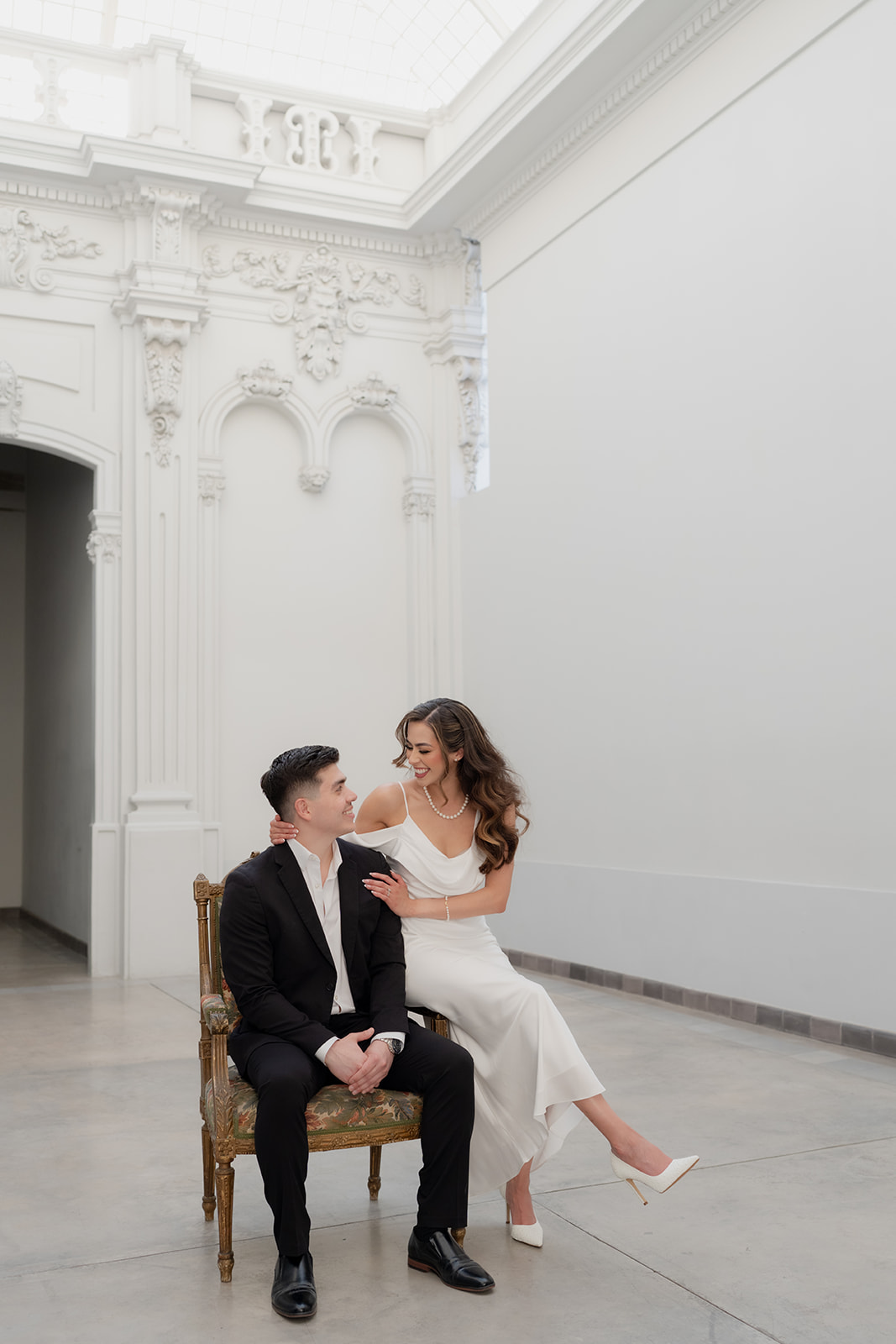 Kelsey and Jose Elias seated together in an ornate room